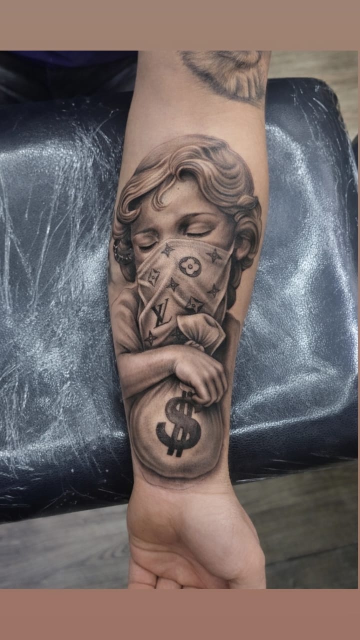 Black & Grey realistic cherub tattoo with LV mask on arm